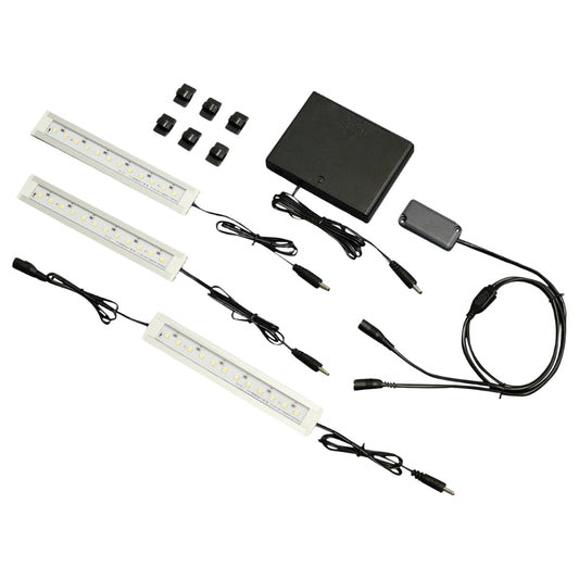 Complete set of Stack-On SPALDC-1703 LED Safe Light Kit, displaying three white LED strips, a battery pack, motion sensor, and mounting clips for customizable installation.