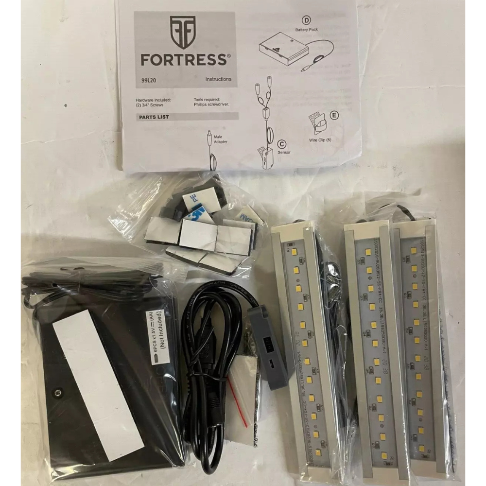 Unpackaged Fortress Battery Powered LED Light Bar Kit displayed with three LED strips, a battery pack, instruction manual, mounting clips, and screws, all arranged for assembly.