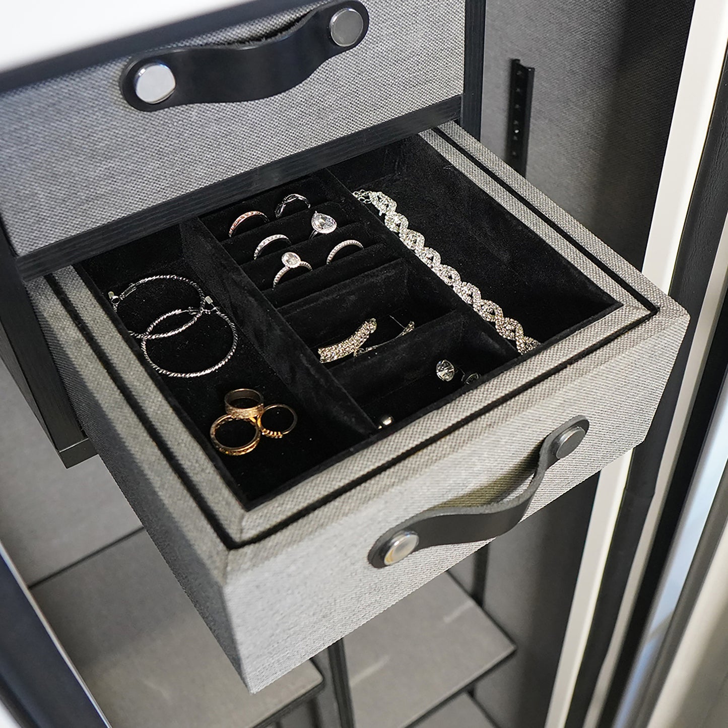 Close-up of the built-in jewelry box inside the white safe, showcasing soft lining and multiple compartments for organized storage.